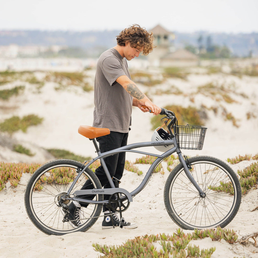Close-up of wide BigWave cruiser bike tires on a sandy beach trail showing tread grip