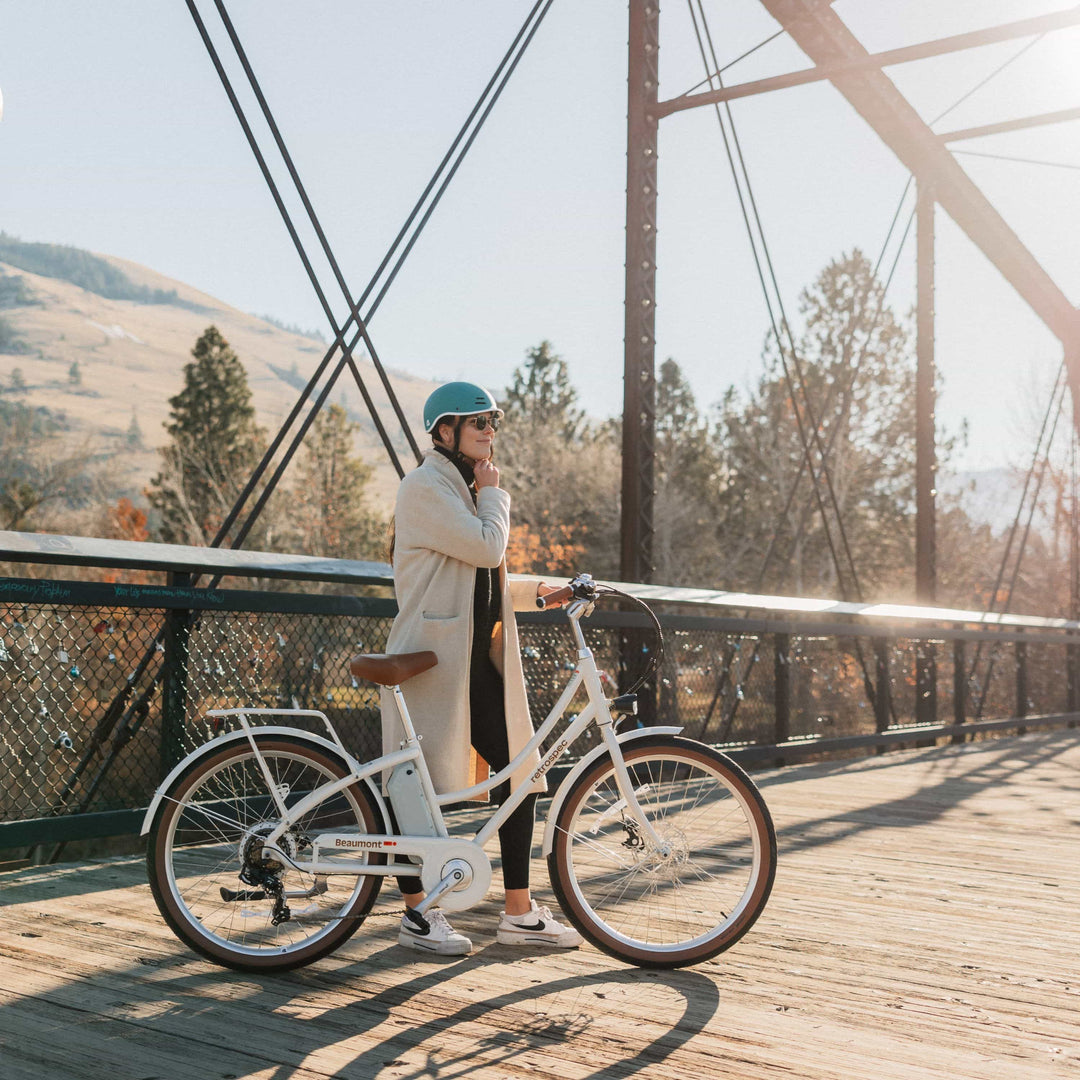 Retrospec Beaumont Rev electric commuter bike on a city street, showing a lightweight city-ready e-bike built for urban riding.