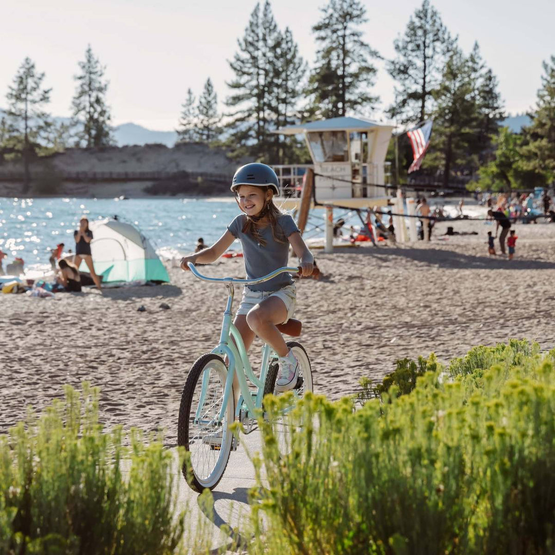 Child confidently riding the Chatham 24 kids beach cruiser bike, ready for a safe and comfortable beach day