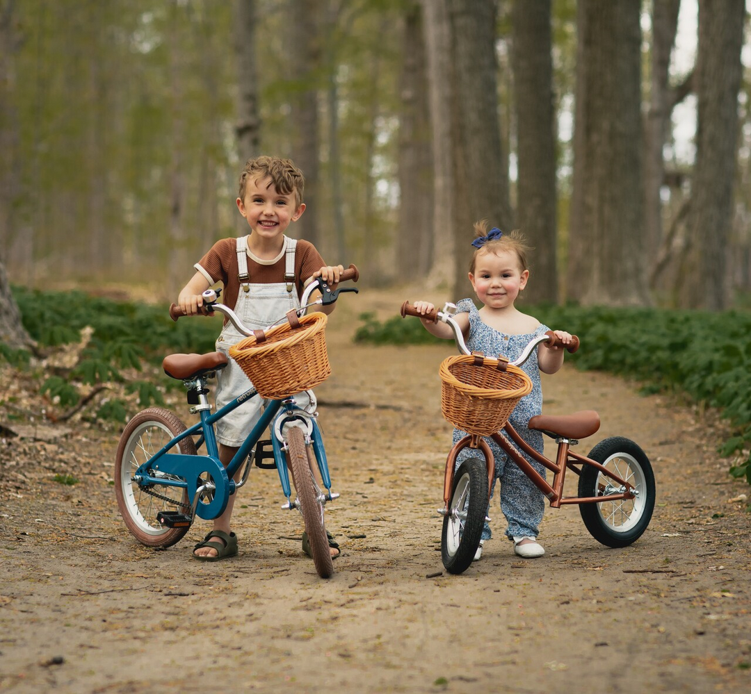 retrospec girls bike with wicker basket on forest trail, child rider with boy on blue bike