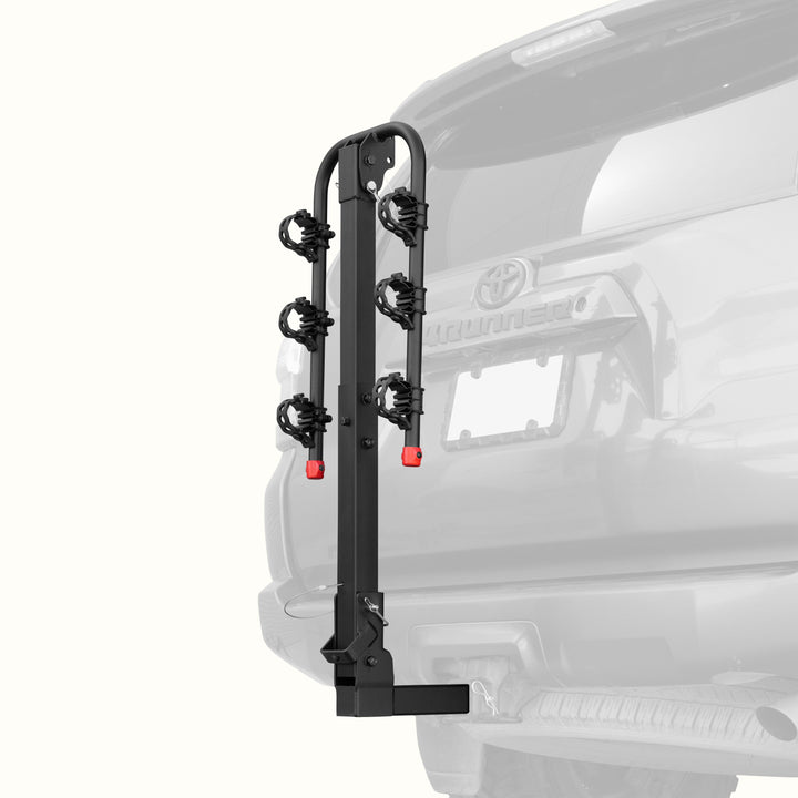 retrospec Lenox Hitch Mount Car Bike Rack (3-Bikes)
installed on the rear of a Toyota 4Runner, shown empty in the folded upright position with cradle arms raised and red safety caps in place.