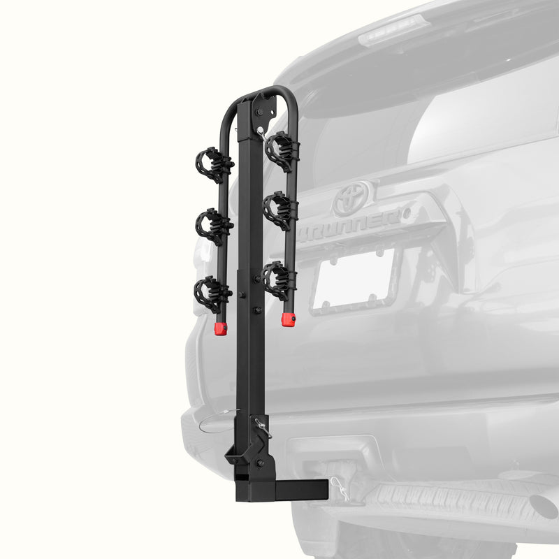 retrospec Lenox Hitch Mount Car Bike Rack (3-Bikes)
installed on the rear of a Toyota 4Runner, shown empty in the folded upright position with cradle arms raised and red safety caps in place.