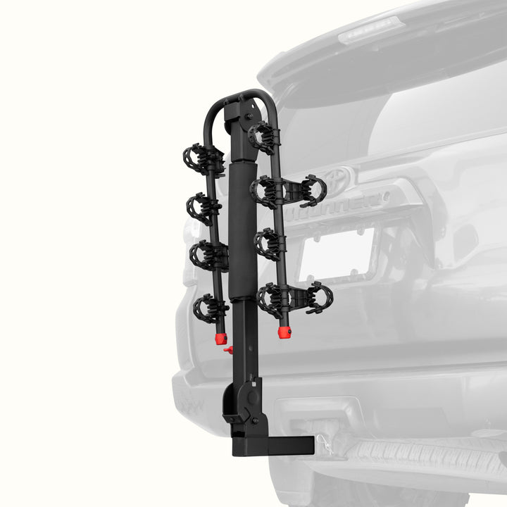 retrospec Lenox Plus Hitch Mount Car Bike Rack (4-Bikes)
installed on the rear of a Toyota 4Runner, shown empty in the folded upright position with cradle arms raised and red safety caps in place.
