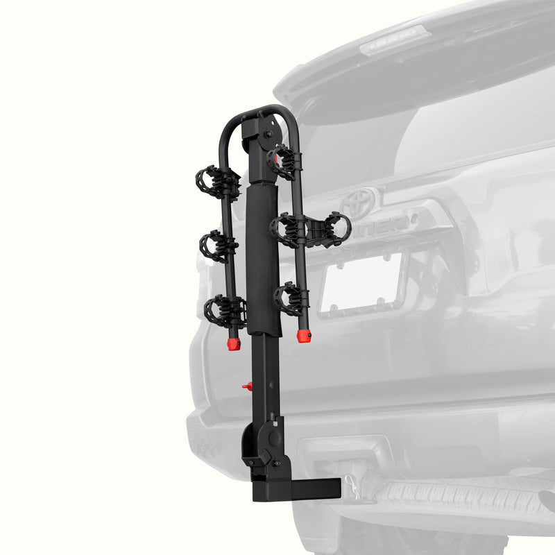 retrospec Lenox Plus Hitch Mount Car Bike Rack (3-Bikes)
installed on the rear of a Toyota 4Runner, shown empty in the folded upright position with cradle arms raised and red safety caps in place.