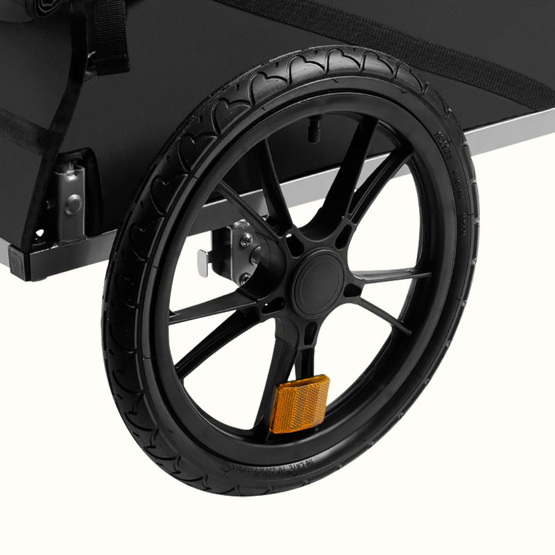 Close-up of a Rover Trailer black wheel with a white background.