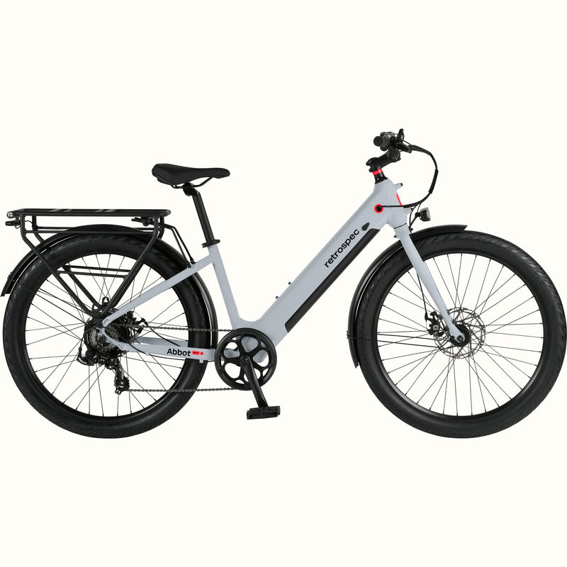 A modern, sleek Abbot Rev 2 Step Through electric bike in gray with a low step-through frame, wide tires, and a rear rack, branded "retrospec."