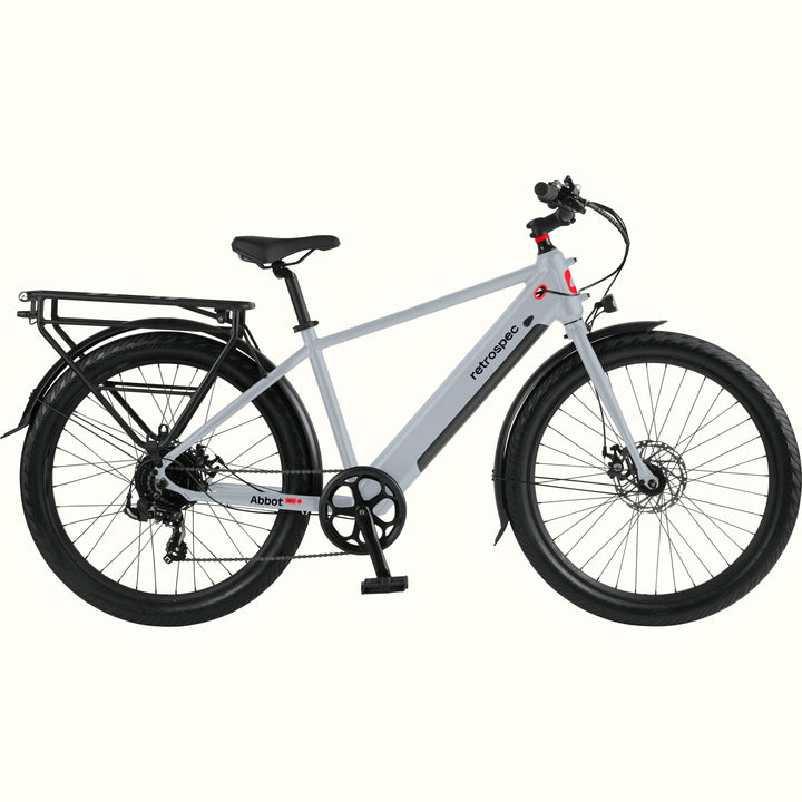 Gray Abbot Rev 2 Commuter Electric Bike with red accents and rear rack on a white background.