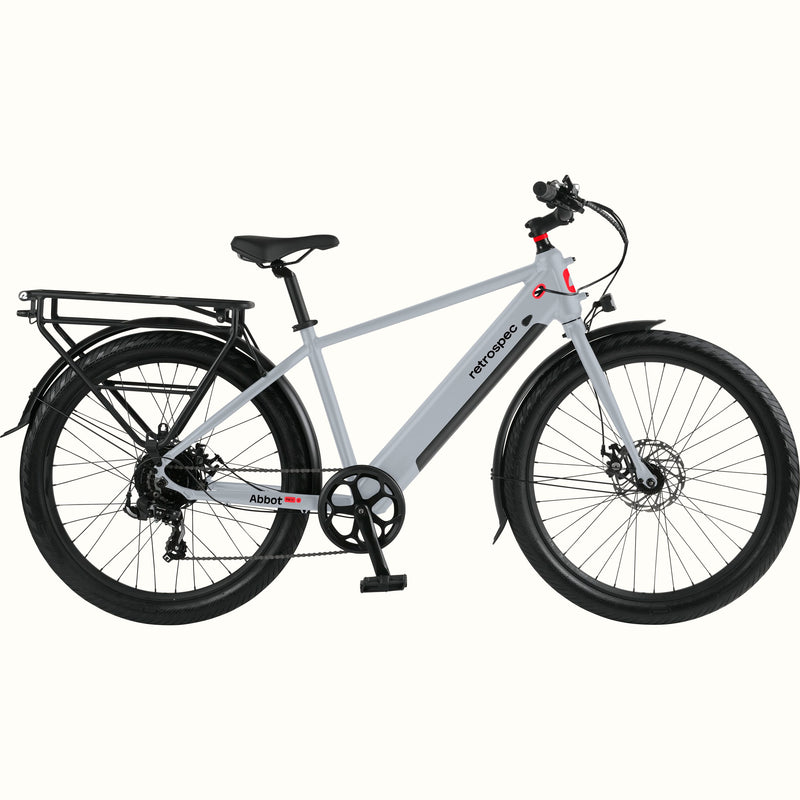 Gray Abbot Rev 2 Commuter Electric Bike with red accents and rear rack on a white background.