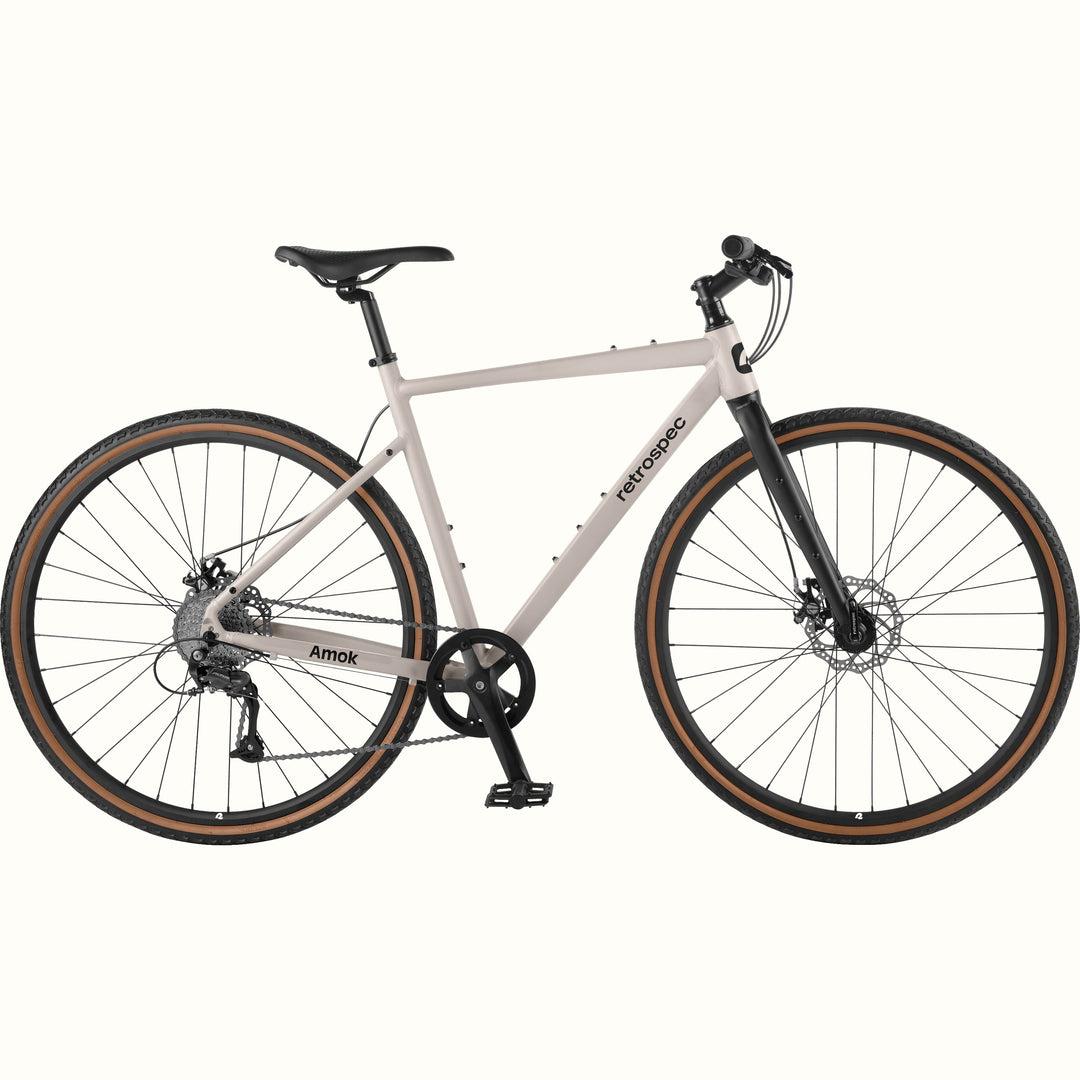 Gray bicycle with black components on a white background.