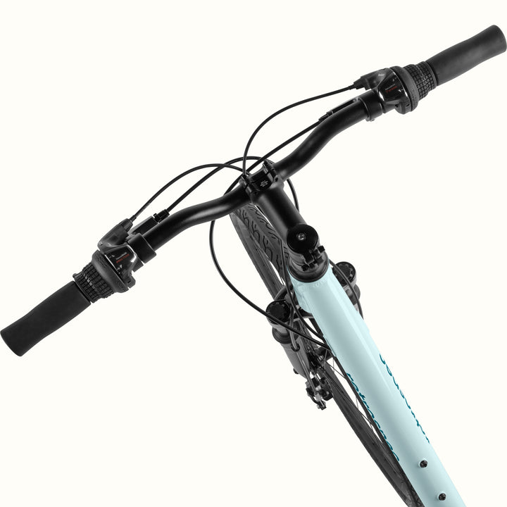 retrospec Barron Plus handlebar close-up in larimar, showing twist shifter, brake lever, and suspension fork crown.