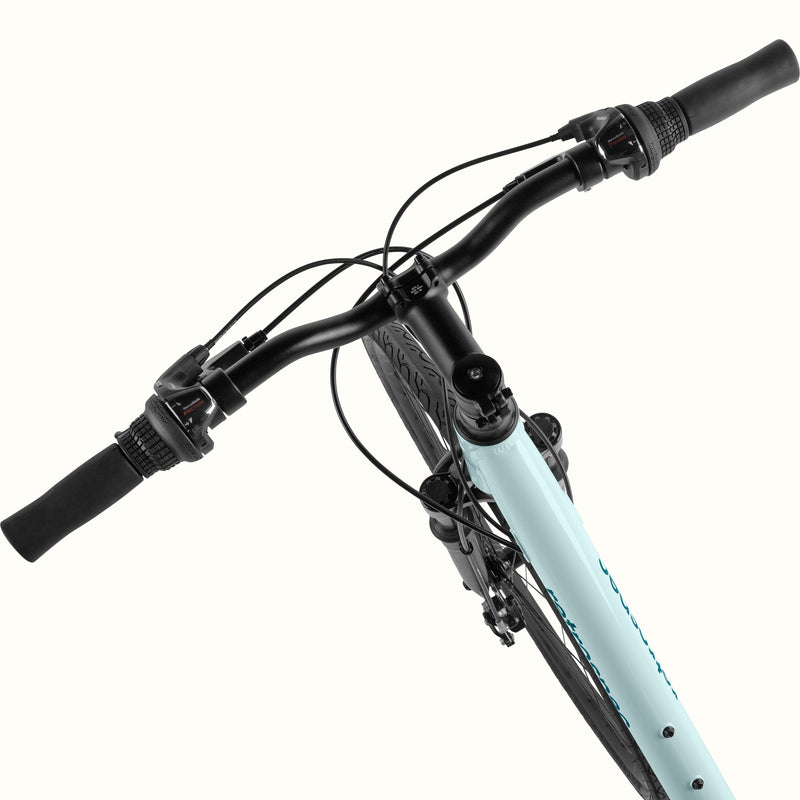 retrospec Barron Plus handlebar close-up in larimar, showing twist shifter, brake lever, and suspension fork crown.