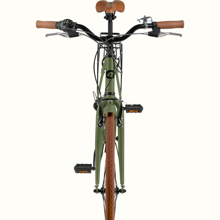 retrospec Beaumont commuter bike with rack, showing swept handlebars, bell, and multi-speed shifter in matte olive drab.