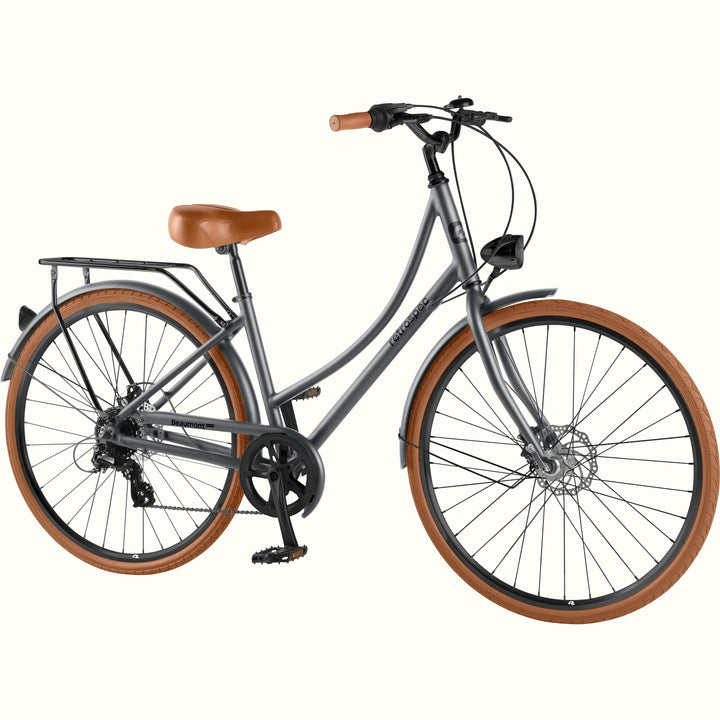 retrospec Beaumont Plus hybrid bike in matte graphite with brown tires, rear rack, fenders, and front headlight.