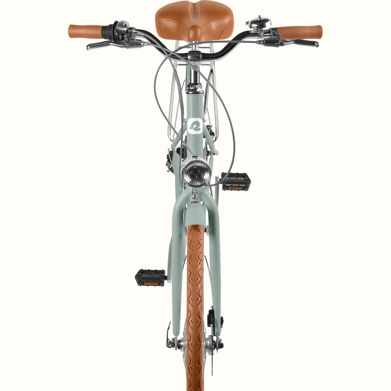 retrospec Beaumont Plus step through city bike in sage haze with front headlight, rear rack, and disc brakes.
