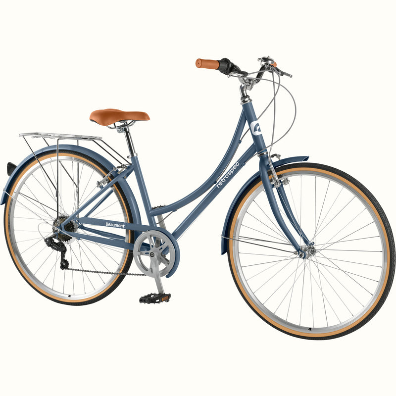 retrospec Beaumont ST step through bike in dusk blue with rear rack, tan tires, and brown leather saddle against white background