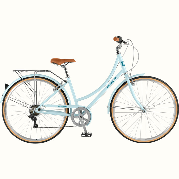 retrospec Beaumont Step Through Commuter Bike in larimar blue with rear rack, tan-wall tires, and brown leather saddle.
