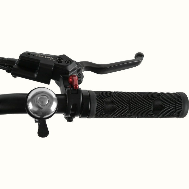 Close-up of the Boca Rev 2 Electric Tricycle's handlebar with brake levers and bell on a white background.