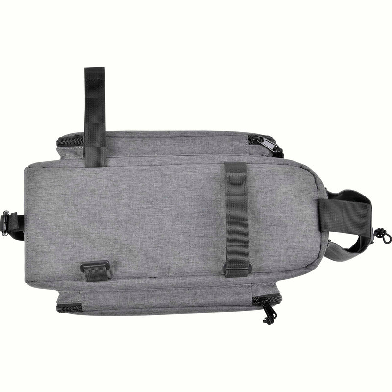 The bottom of a gray heathered bicycle trunk bag with black velcro fastening straps on a white background.