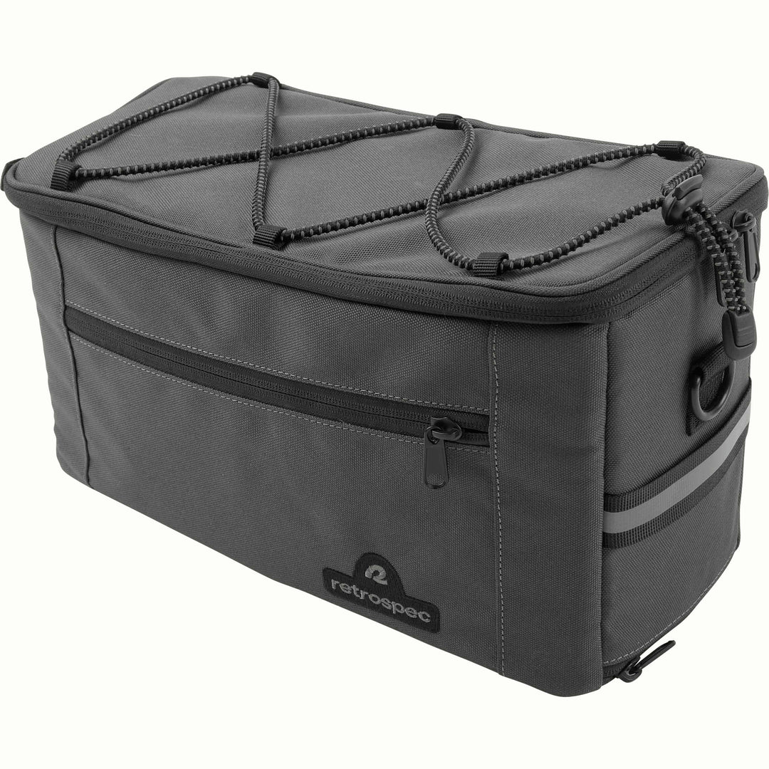 Cahoot Rear Rack Trunk Bike Bag in gray wtih a zippered closure, top bungee cord storage, and a reflective stripe at the rear.