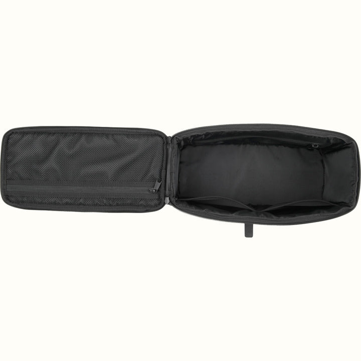 A top view of the black interior of the Cahoot Trunk Bag Stone revealing two empty compartments and a mesh zipper storage area.