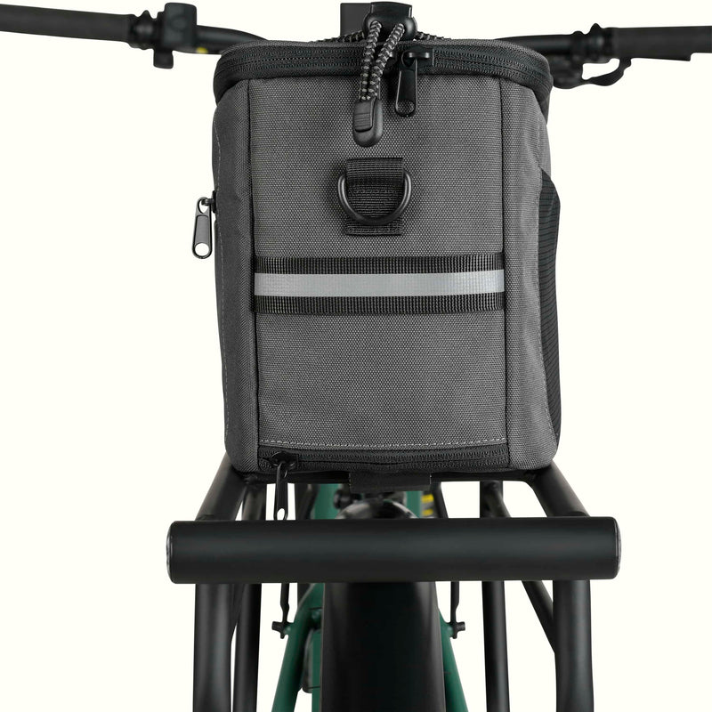 A rear view of the Cahoot Rear Rack Trunk Bag attached to the rear rack of an electric bike.