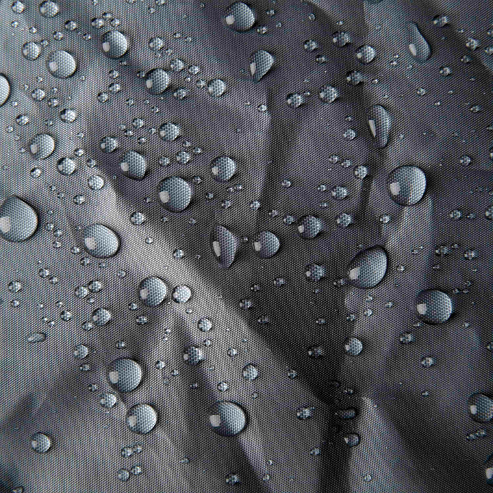 Water droplets on the gray waterproof fabric surface of the Sidekick Duo Saddlebag Rain Cover.