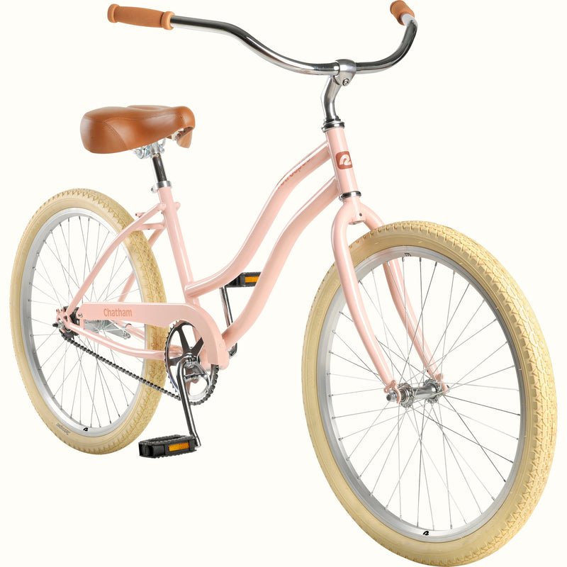 retrospec Chatham 24" kids cruiser bike shown at an angle with a blush pink frame and cream tires.
