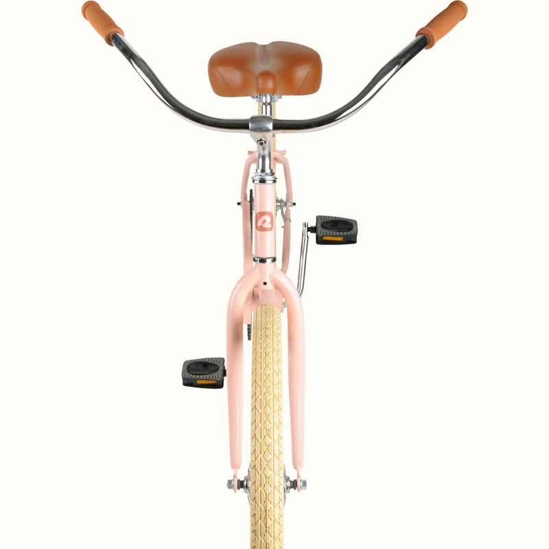 close-up of the retrospec Chatham 24" kids bike handlebars, tan grips, and brown saddle.