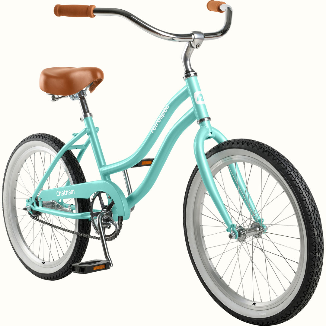 retrospec Chatham kids cruiser bike in seafoam with whitewall tires, chrome fenders, and single-speed chain drive.