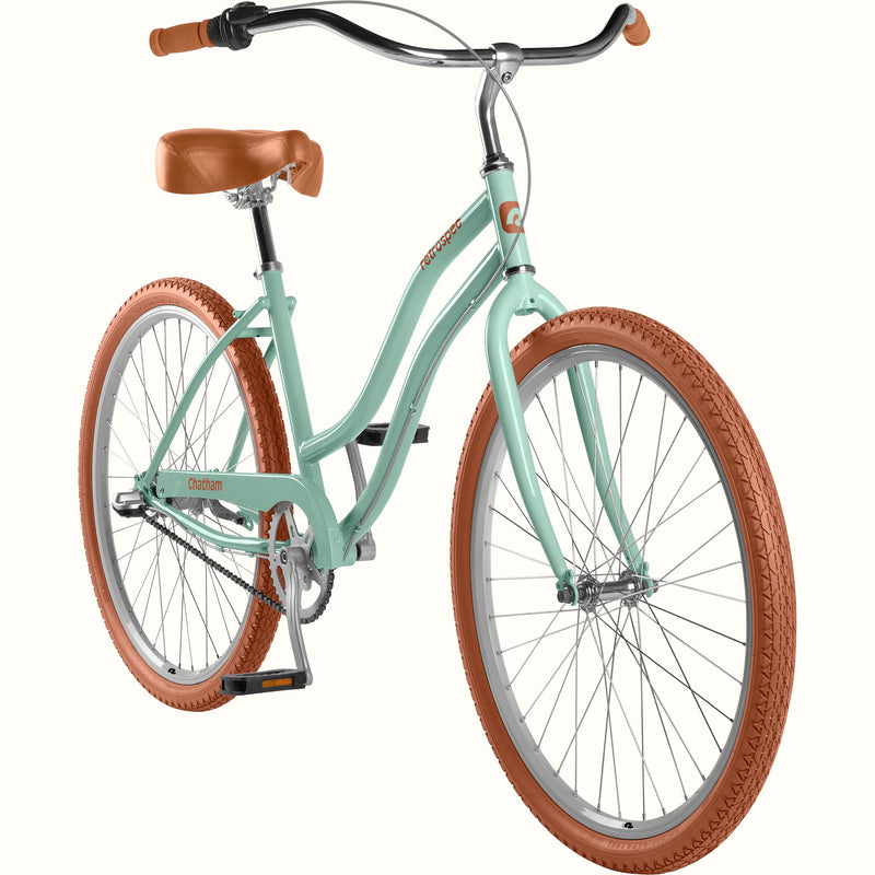 Matcha green beach cruiser bicycle with brown tires and seat on a white background.