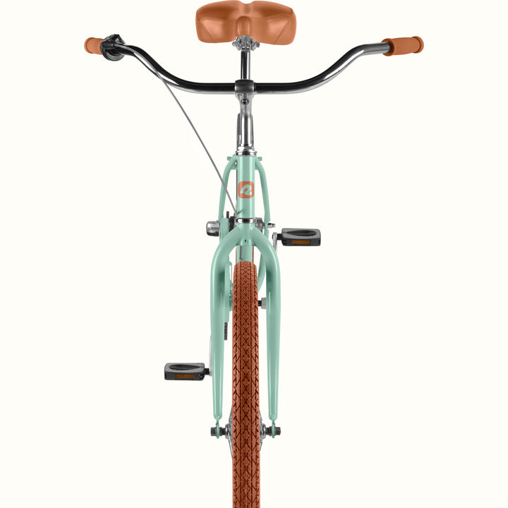 Front view of a bicycle with a matcha green frame, brown saddle and grips, and a brown knobby tire, shown on a plain light background.