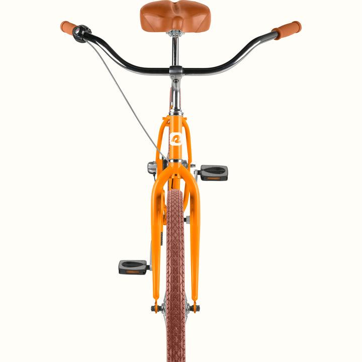 Front view of the retrospec Chatham cruiser bicycle handlebar, headtube logo, and orange fork with brown tire.