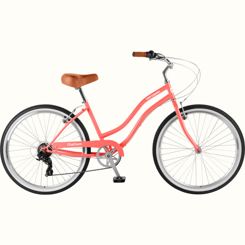 retrospec Chatham step through cruiser bike in coral pink, side profile showing the low-step frame.