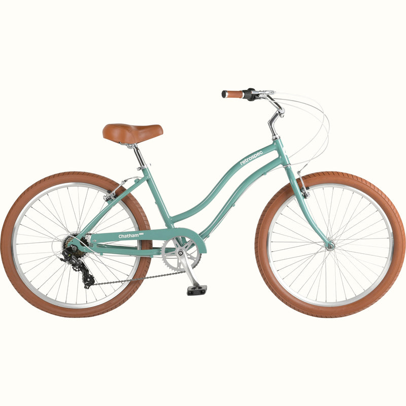 A mint green cruiser bicycle with brown seat and handlebars, and white-wall tires.