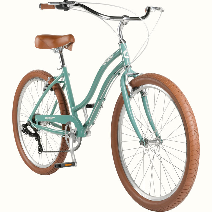 A mint green cruiser bicycle with a brown saddle and brown tires isolated on a white background