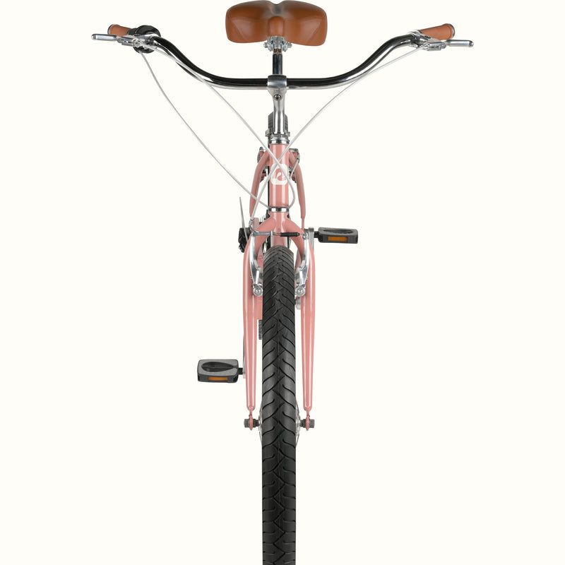 Front view of a pink cruiser bicycle with brown seat and grips.