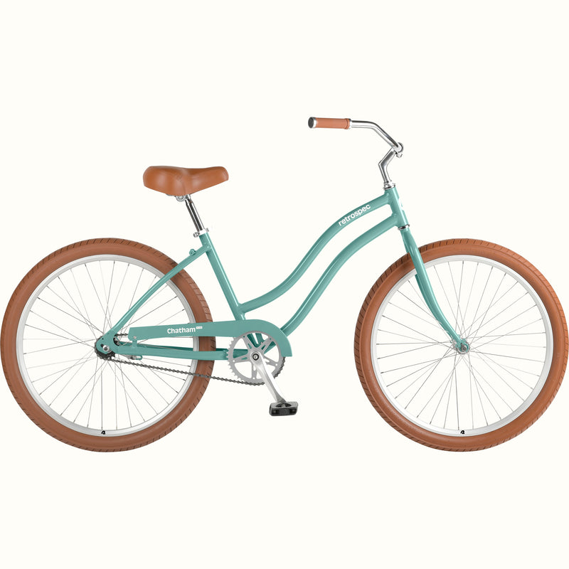 retrospec Chatham Plus women's cruiser bike in aquastone with tan tires, brown leather saddle, and step-through steel frame, side view.
