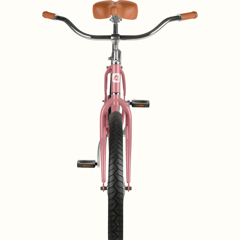 front-facing close-up of retrospec Chatham Plus ladies cruiser bike in dusty rose showing wide handlebars, brown grips, and black tread tire.