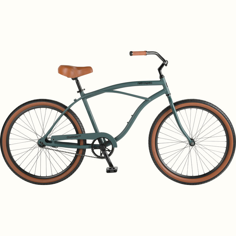 A green cruiser bicycle with brown seat and grips, white background.