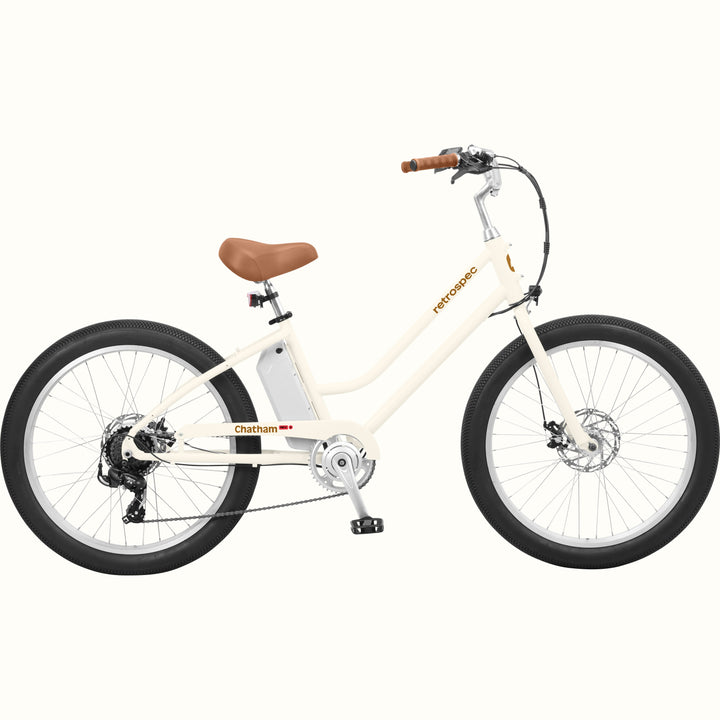 An eggshell Chatham Rev 3 Beach Cruiser Electric Bike - Step Through with a brown seat, wide tires, and a sleek design, ideal for casual riding.