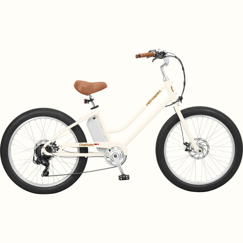 An eggshell Chatham Rev 3 Beach Cruiser Electric Bike - Step Through with a brown seat, wide tires, and a sleek design, ideal for casual riding.