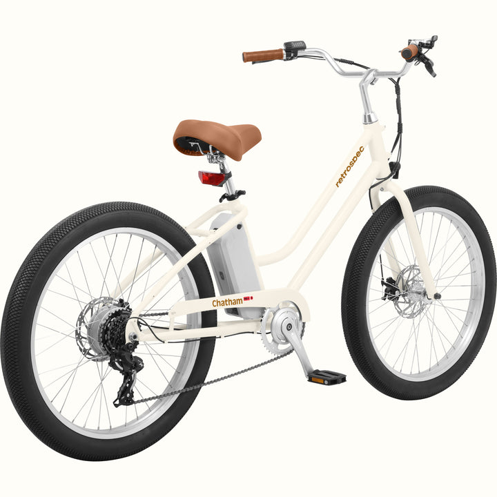 An eggshell Chatham Rev 3 Beach Cruiser Electric Bike - Step Through with a brown seat, wide tires, and a sleek design, ideal for casual riding.