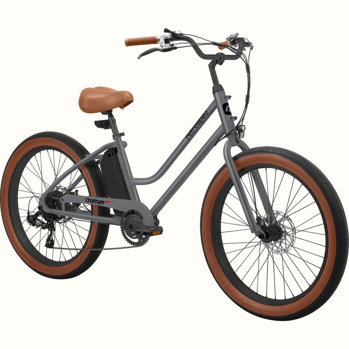 A matte graphite Chatham Rev 3 Beach Cruiser Electric Bike - Step Through with a brown seat, wide tires, and a sleek design, ideal for casual riding.