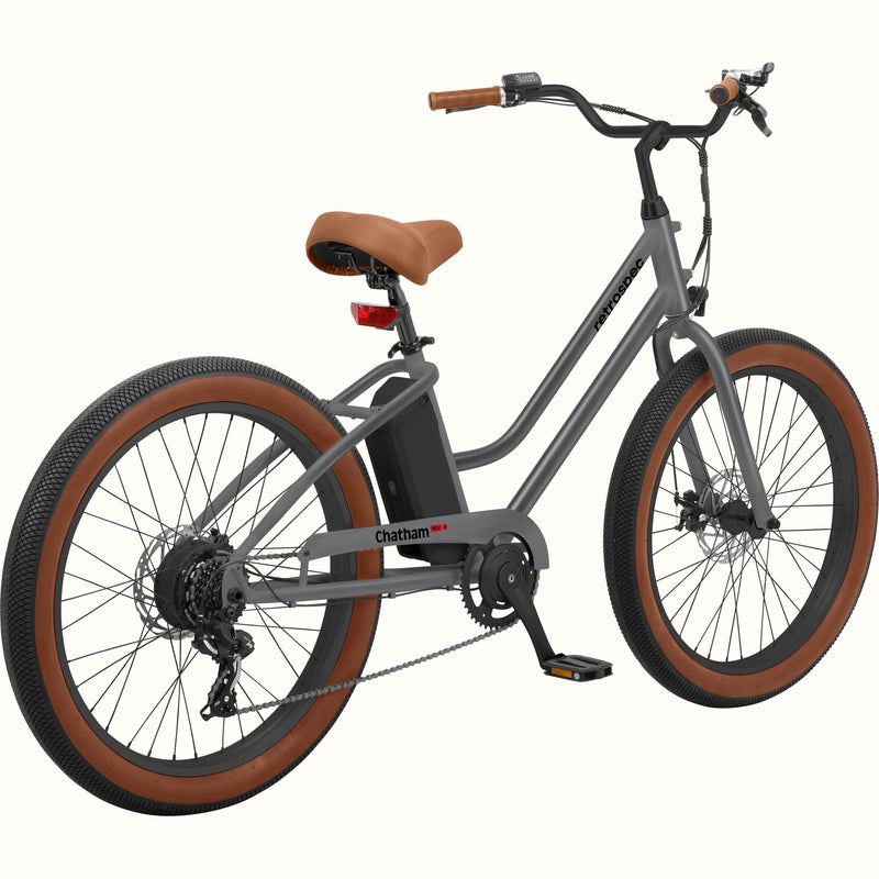 A matte graphite Chatham Rev 3 Beach Cruiser Electric Bike - Step Through with a brown seat, wide tires, and a sleek design, ideal for casual riding.