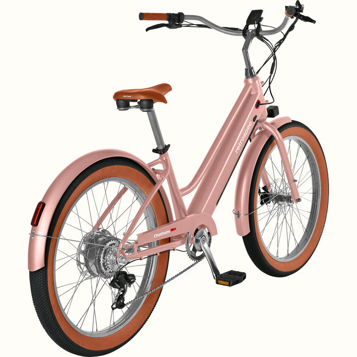 Pink Chatham Rev+ 2 Beach Cruiser Electric Bike - Step Through with brown wheels on a white background.