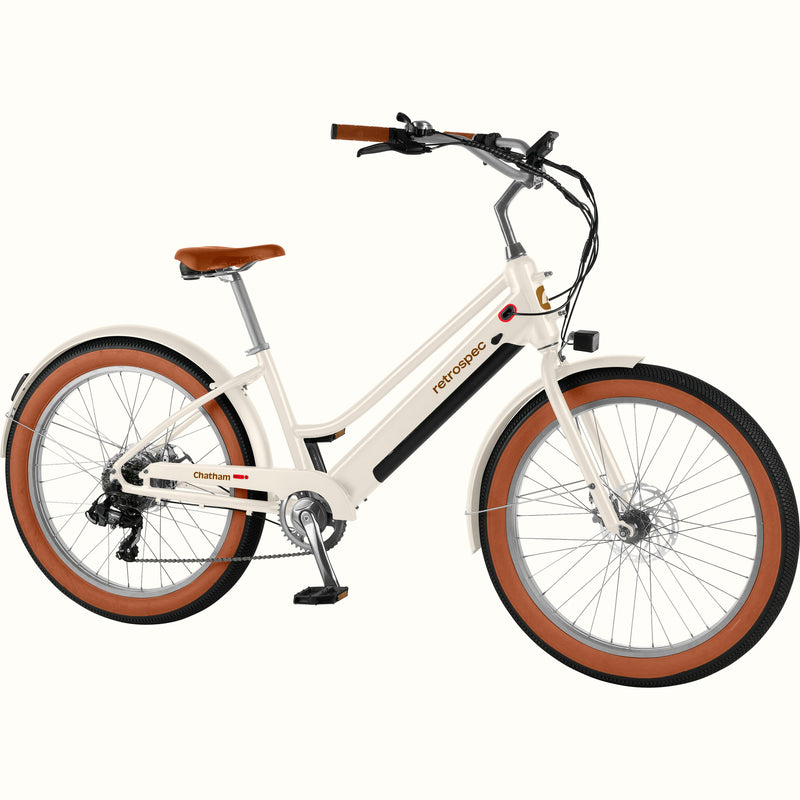 White Chatham Rev+ 2 Beach Cruiser Electric Bike - Step Through with brown wheels on a white background.