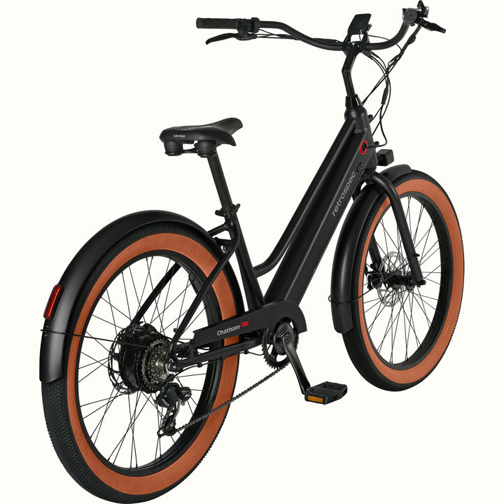 Black Chatham Rev+ 2 Beach Cruiser Electric Bike - Step Through with brown wheels on a white background.