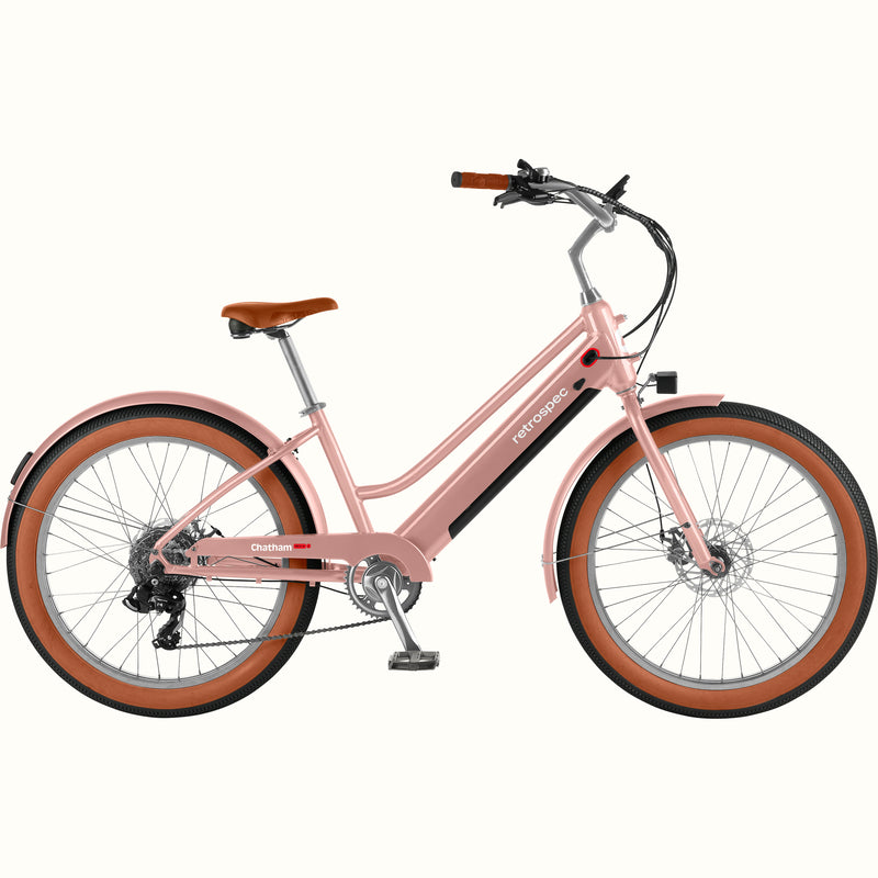 Pink Chatham Rev+ 2 Beach Cruiser Electric Bike - Step Through with brown wheels on a white background.