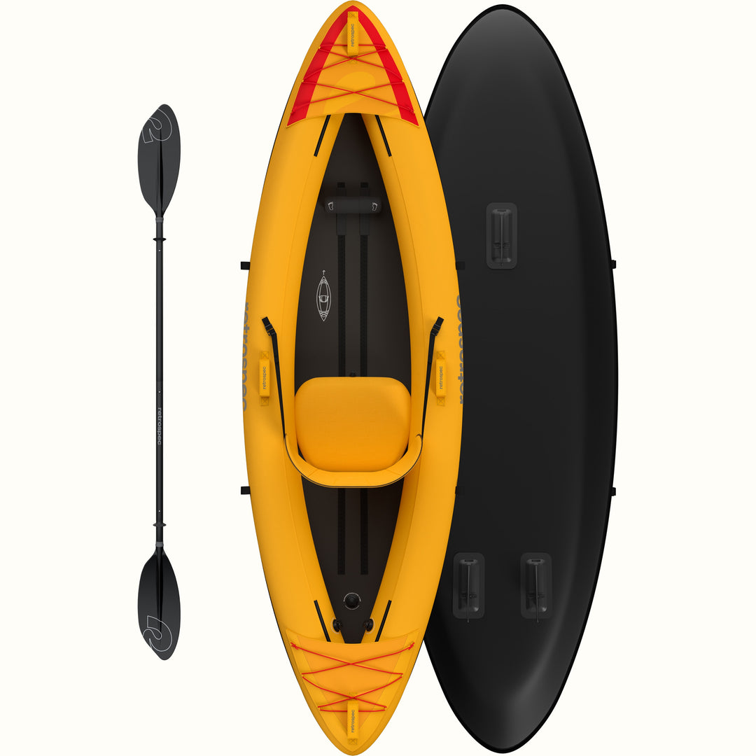 An overhead view of a bright yellow inflatable kayak with a comfortable seat and adjustable straps, accompanied by a black paddle.