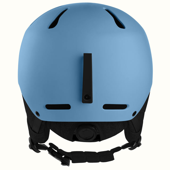 A matte blue ski helmet shown from the back, featuring black ventilation slots, a central vertical vent, and a black adjustable chin strap with plastic buckles, set against a plain white background.